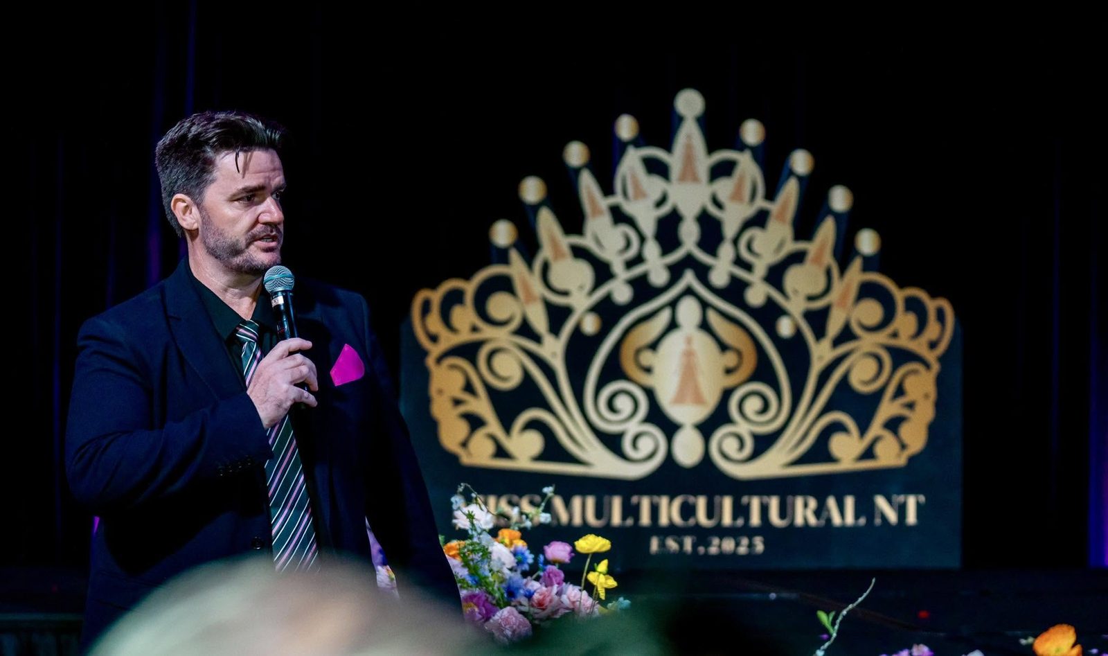 Mark Barnes hosting on stage at Miss Multicultural Australia